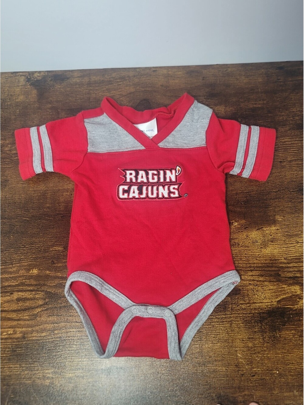 Two Feet Ahead Ragin Cajuns Bodysuit